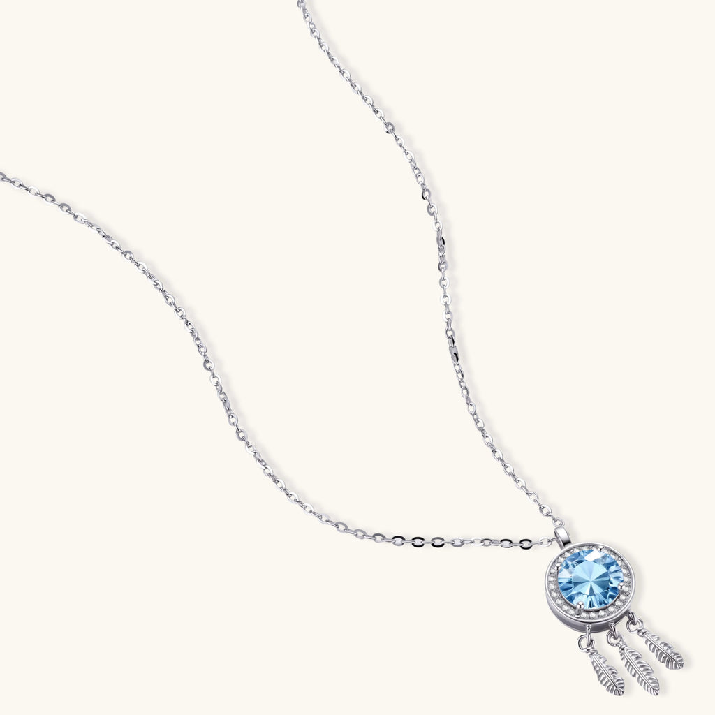 Sterling silver dreamcatcher pendant with blue moissanite center and three feather charms on adjustable chain.