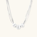 Sterling silver multi-strand necklace with three brushed round beads on cream background